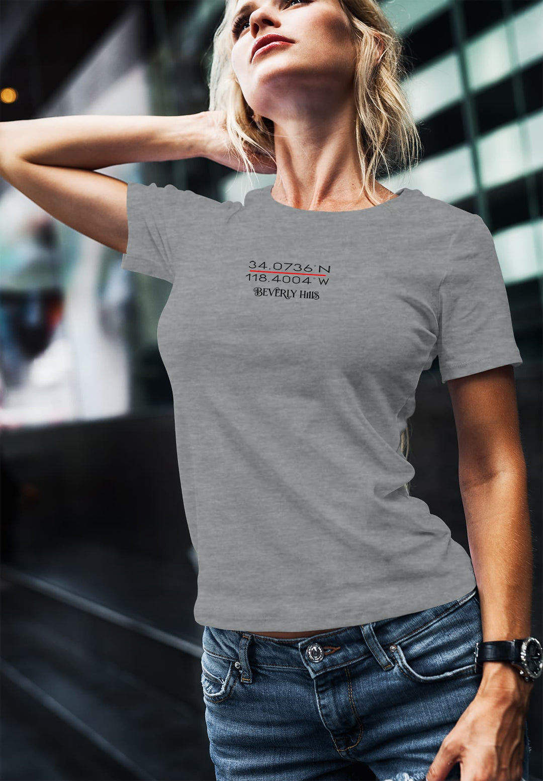 A woman poses in jeans and a gray short-sleeve shirt, perfectly embodying laid-back style and timeless comfort.