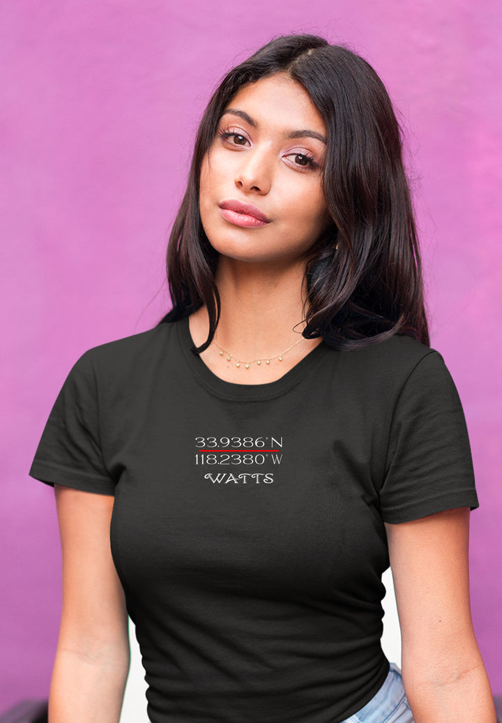 With flowing long hair, the woman exudes confidence, posing in a simple yet powerful black tee, capturing a captivating essence.