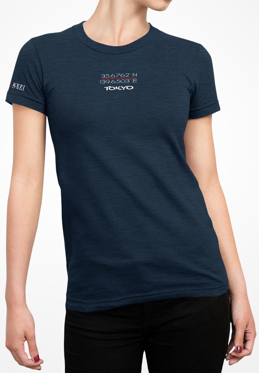 She strikes a pose, adorned in a serene blue T-shirt paired with timeless black jeans, embodying casual style.