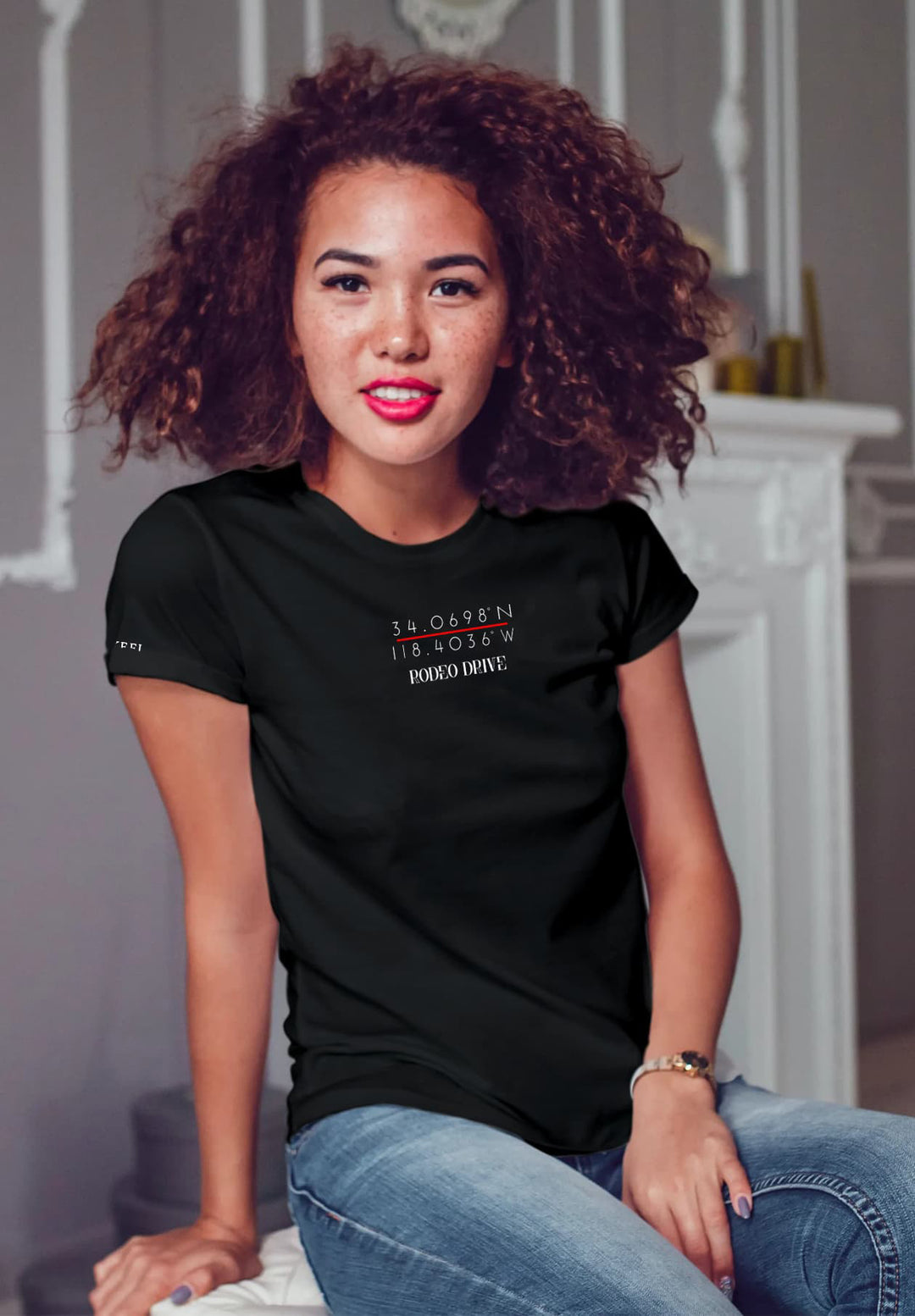 Radiating chic vibes, a woman sits confidently in a classic black T-shirt, accentuated by the bold allure of red lipstick.