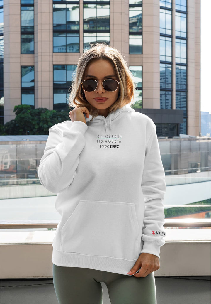 A woman embraces comfort and style in leggings paired with a white pullover.