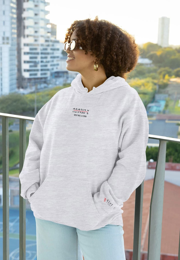 With her beaming smile, the woman's gray pullover hoodie captures a moment of genuine joy and cozy comfort.