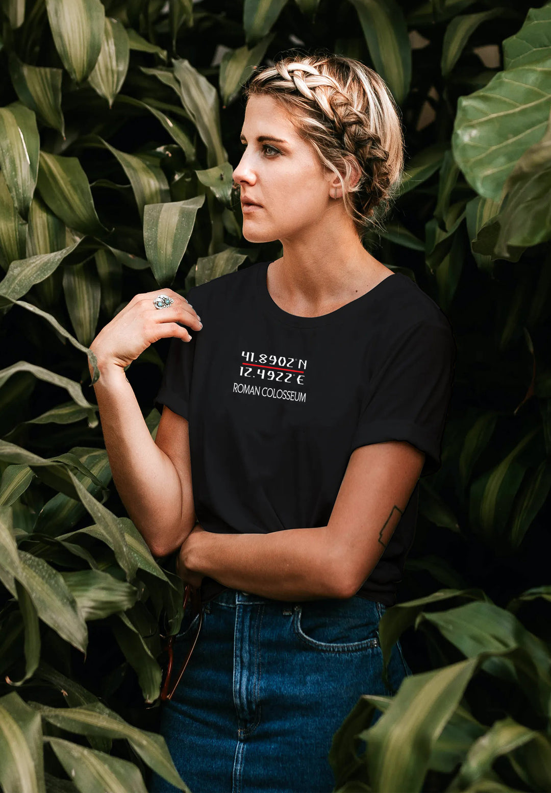 Amid lush greenery, she stands adorned in a black T-shirt, a harmonious blend of nature's backdrop and her effortless style.