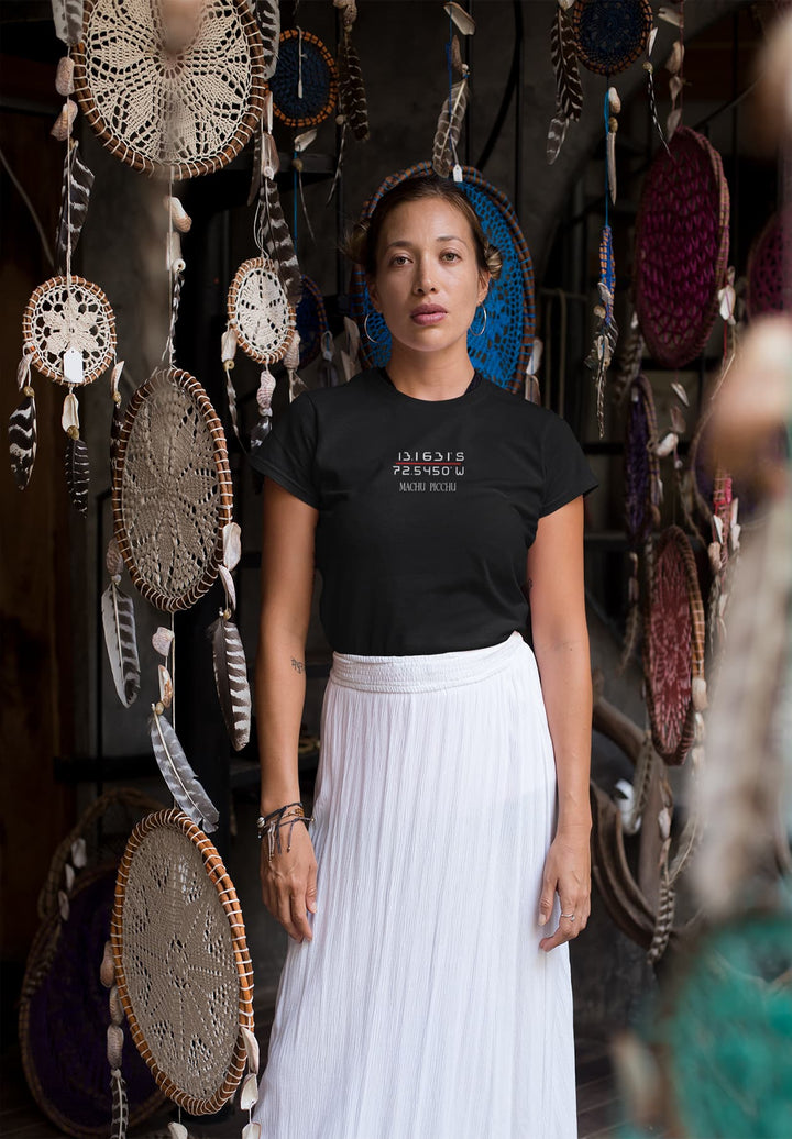 The lady in a black t-shirt embraces a blend of earthy tones and heavenly energy as she stands before a backdrop of dream catchers.