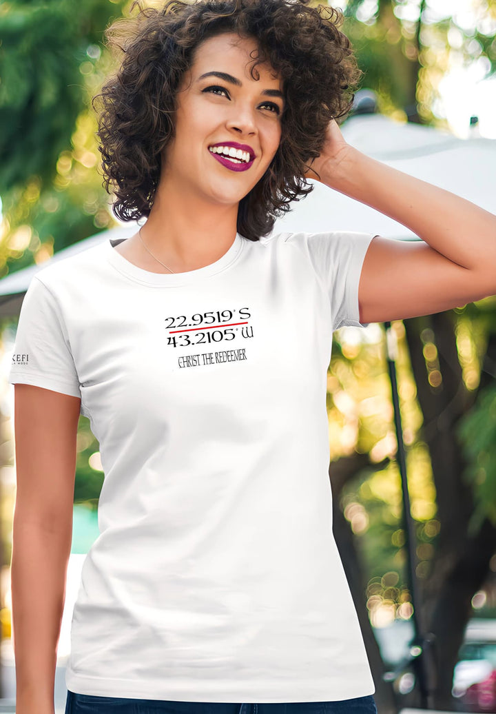 A woman in a white t-shirt radiates excitement, her contagious smile turning a simple moment into a sincere celebration of positive.