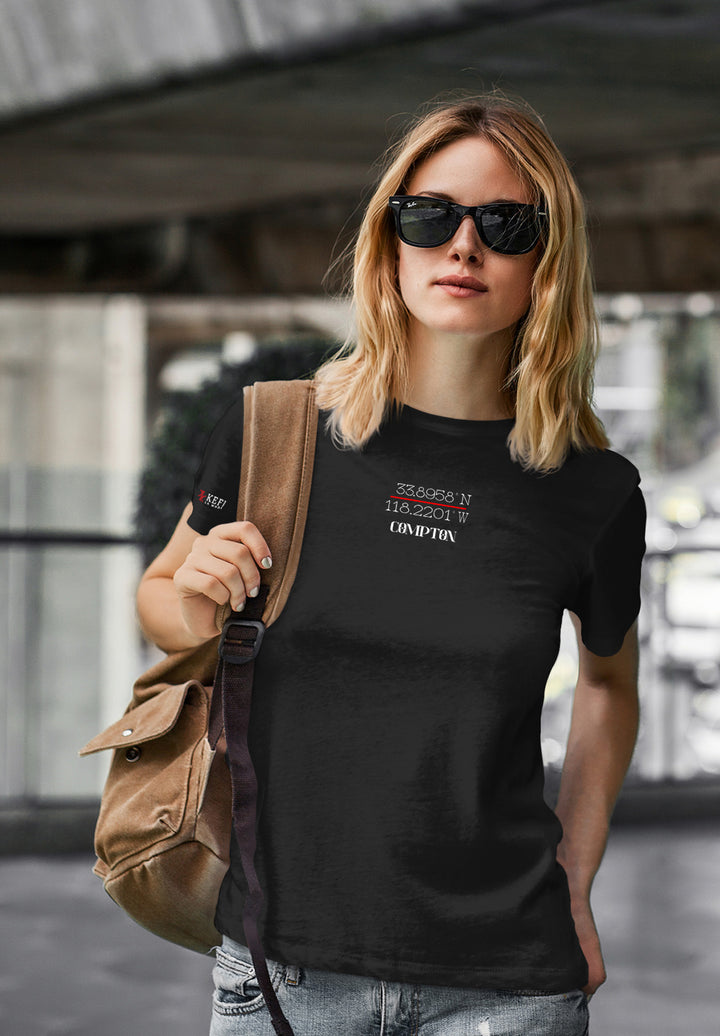 A woman with a black t-shirt and sunglasses walks with confidence and style, turning the average stroll into a compelling display of uniqueness.