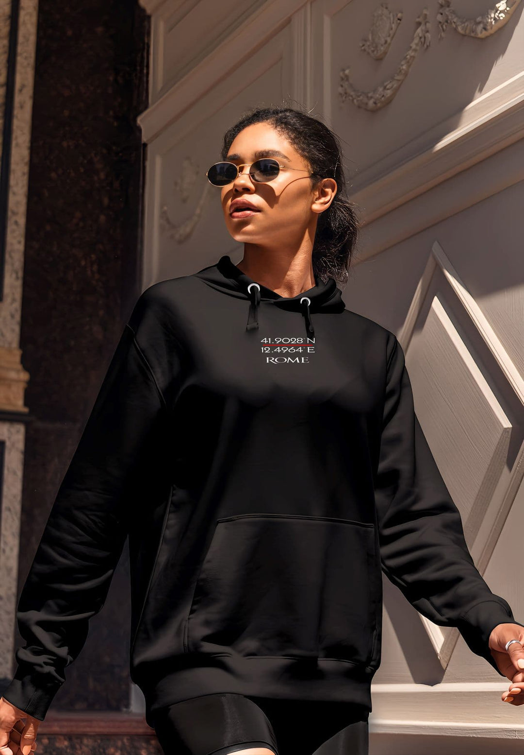  In the soft embrace of a black hooded sweatshirt and shorts, the woman  embracing one's true self.  