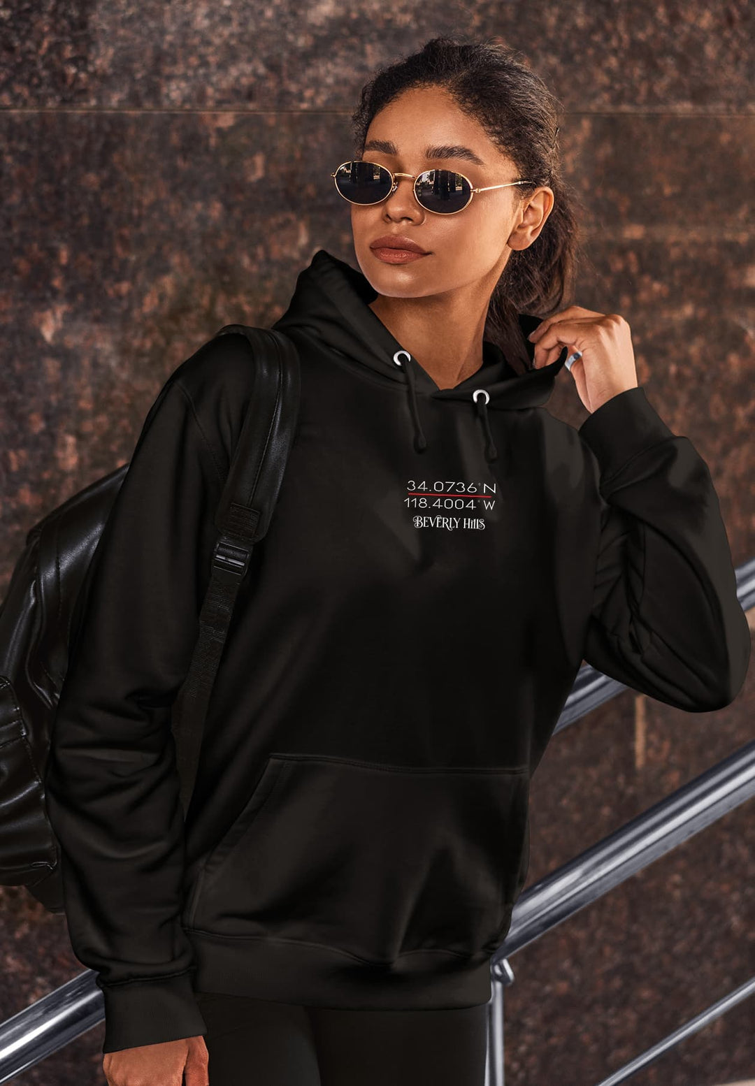 The black hoodie she is wearing is not just clothing; it's a symbol of a special moment when style and memories blend seamlessly.