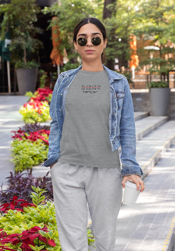 Radiating casual elegance, a woman dons a gray t-shirt, stylish sunglasses, and a denim jacket, embodying a relaxed yet effortlessly chic vibe.