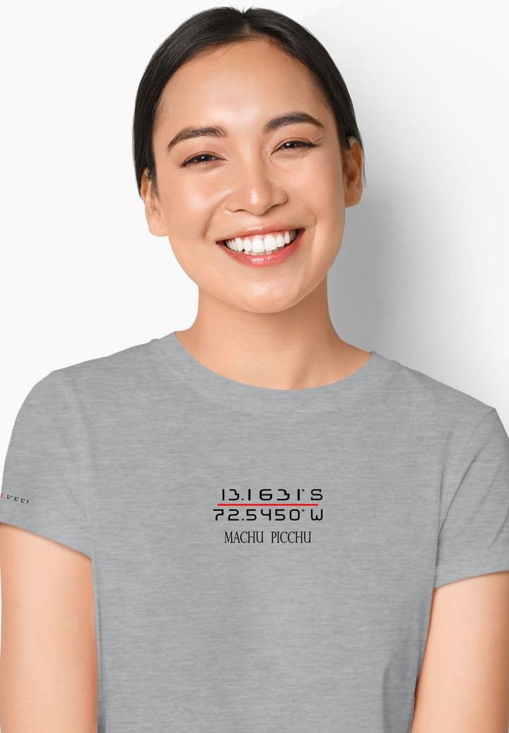 Radiating warmth and joy, a woman captivates in her gray shirt, her smile illuminating the moment with genuine happiness.