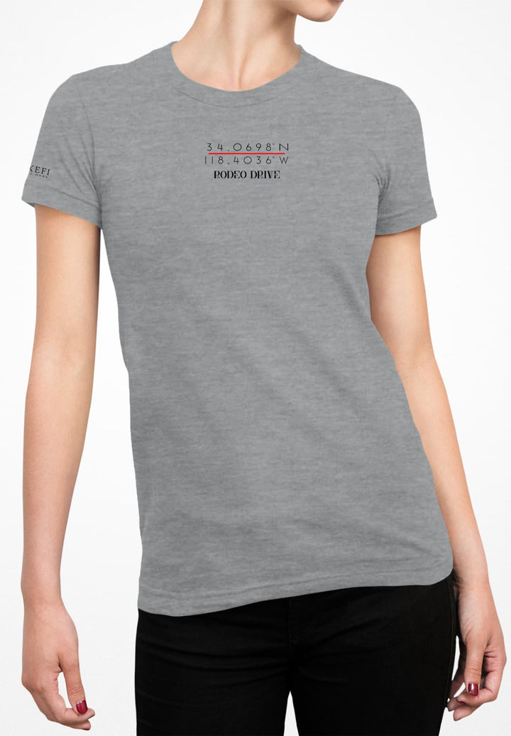 The woman embraces casual elegance with a gray T-shirt and black denim jeans.