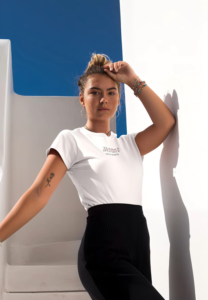 Basking in sunlight, she ascends a sunny stairway adorned in a white t-shirt, exuding a radiant aura and carefree elegance.