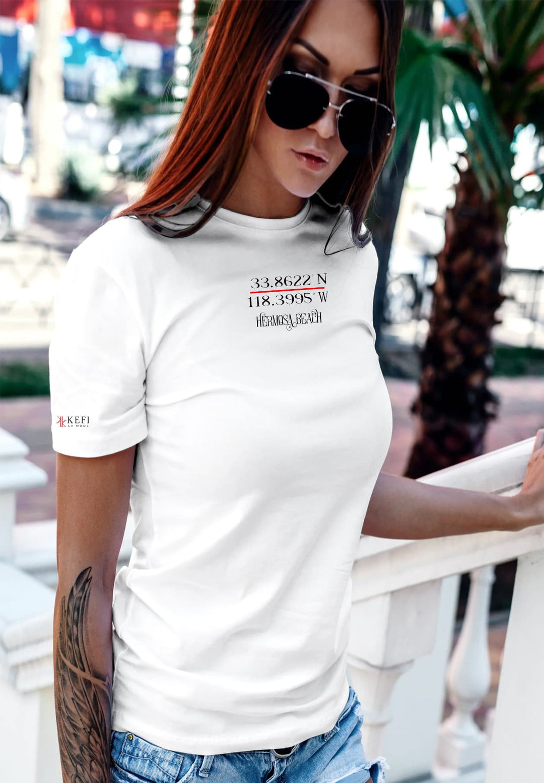 The woman strolling in effortless style, her white t-shirt radiating simplicity and comfort, complemented by sunglasses, jeans, and casual elegance. 