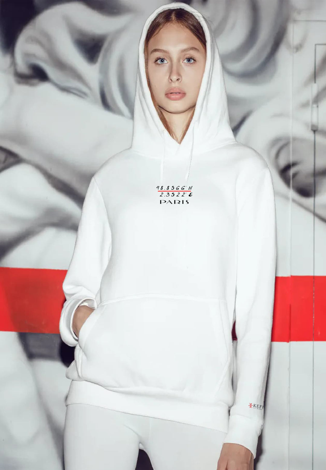Effortlessly chic, the woman flaunts a Paris-inspired hoodie paired with sleek leggings, exuding an air of refined comfort.