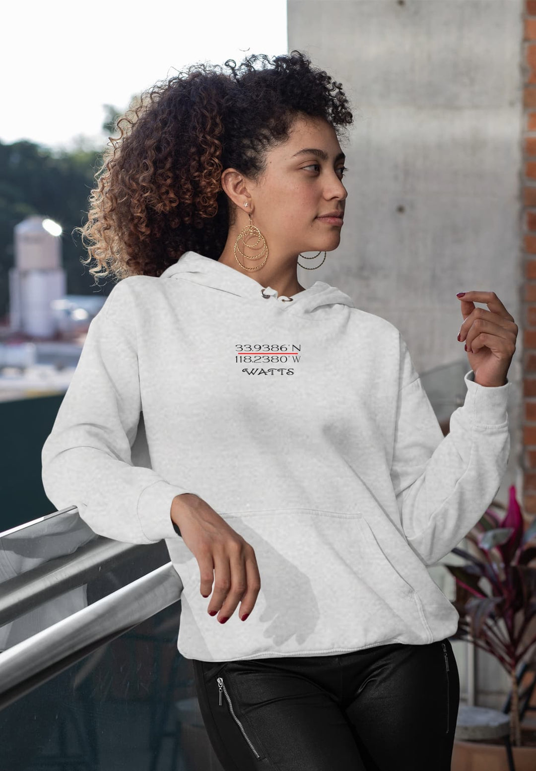 The delicate fall of locks reveals a woman in a gray hoodie that blends comfort and style. 