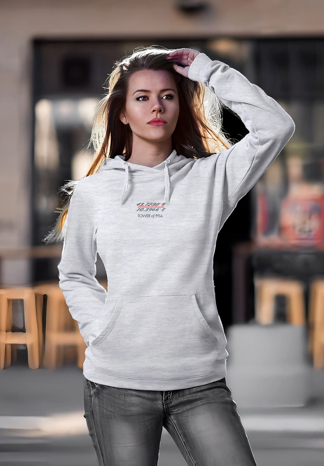 The gray hoodie, a soft barrier between her and the world resonates with a sense of curiosity and perhaps a touch of wistfulness.