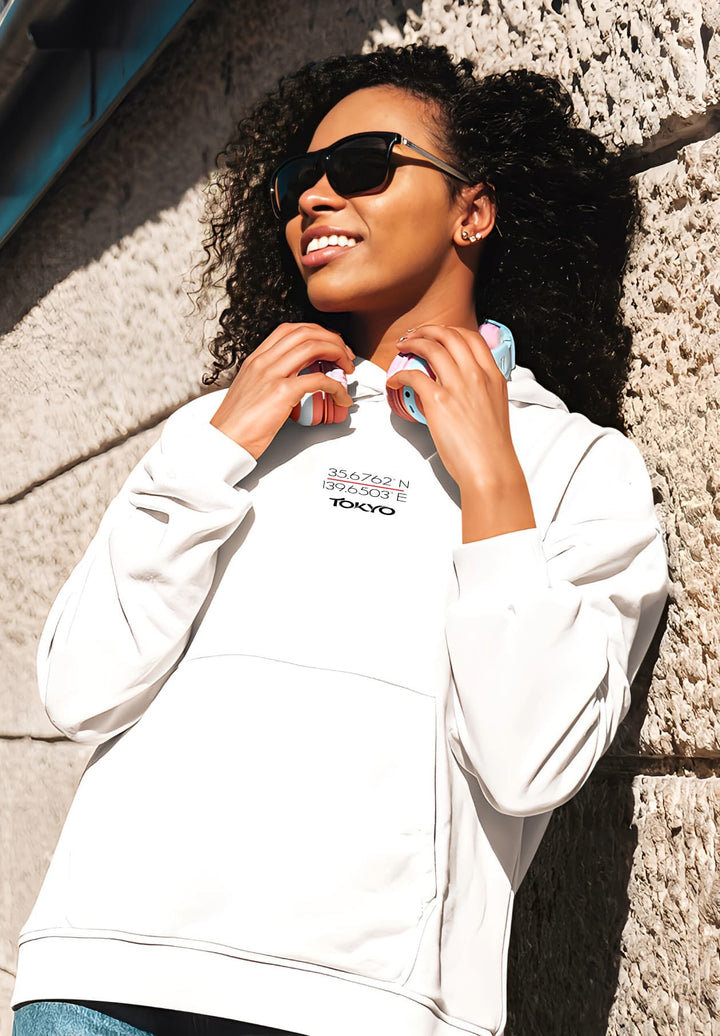 In the glow of daylight, a woman graces the scene, adorned in the purity of a white pullover. 