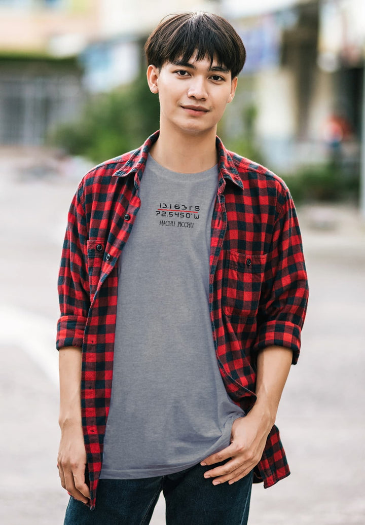 Gracing the empty street, the young man in a gray Machu Picchu tee smiles, carrying echoes of ancient adventures.