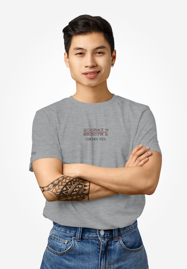 In a gray Chichen Itza tee, arms crossed, he showcases the coordinates, a living tribute to ancient wonders and memories.