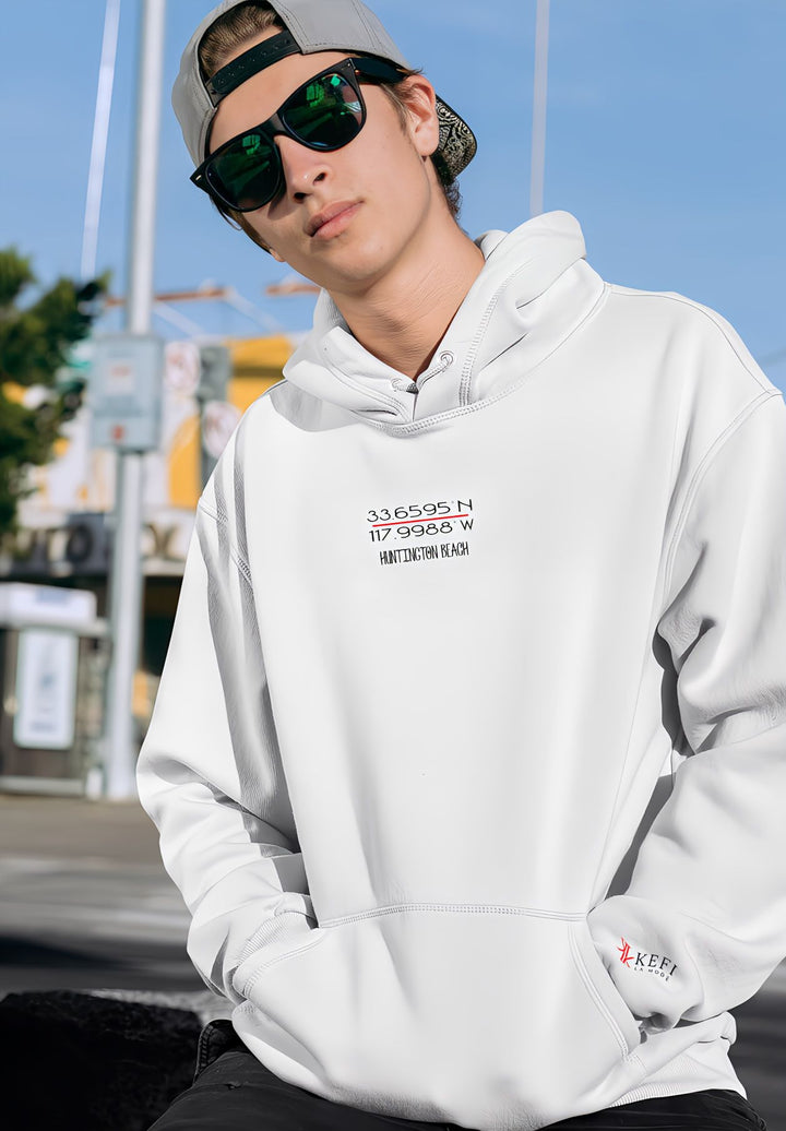 With a white hoodie and sunglasses, the young man sets a fashionable tone.