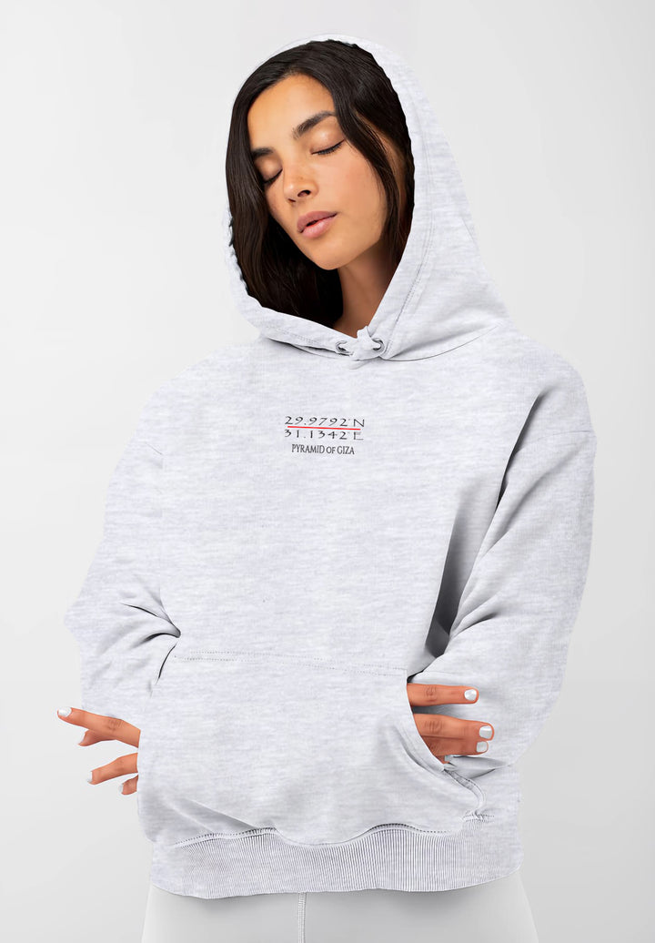 With the Pyramid of Giza coordinates adorning her gray hoodie, the young woman carries a piece of ancient history into the modern world of fashion.