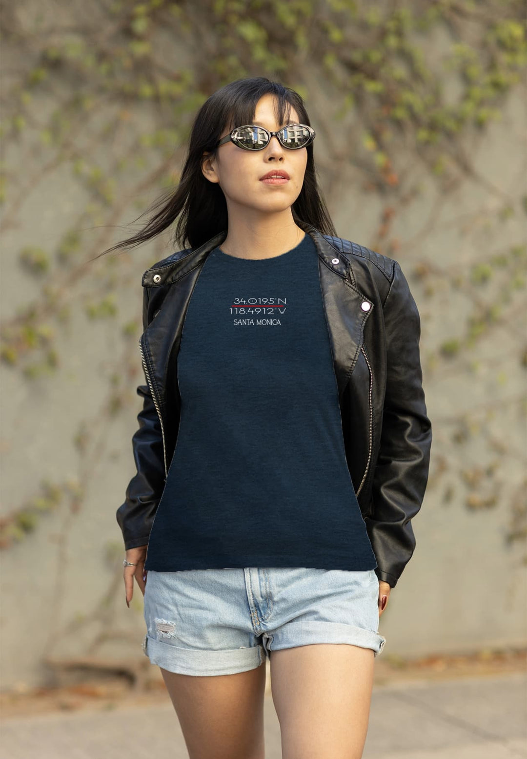 She captures an effortless charm that attracts the surroundings as she stands there looking stylish in denim shorts and a relaxed blue T-shirt.