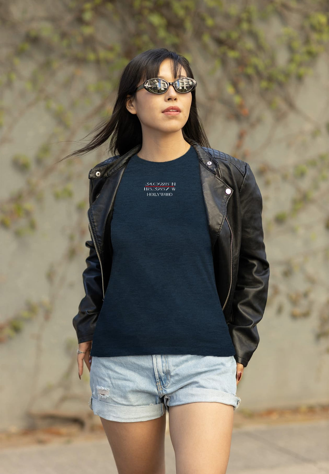 A young woman has a relaxed and fashionable spirit as she wears a blue t-shirt, easily combining casual comfort with a hint of luxury.